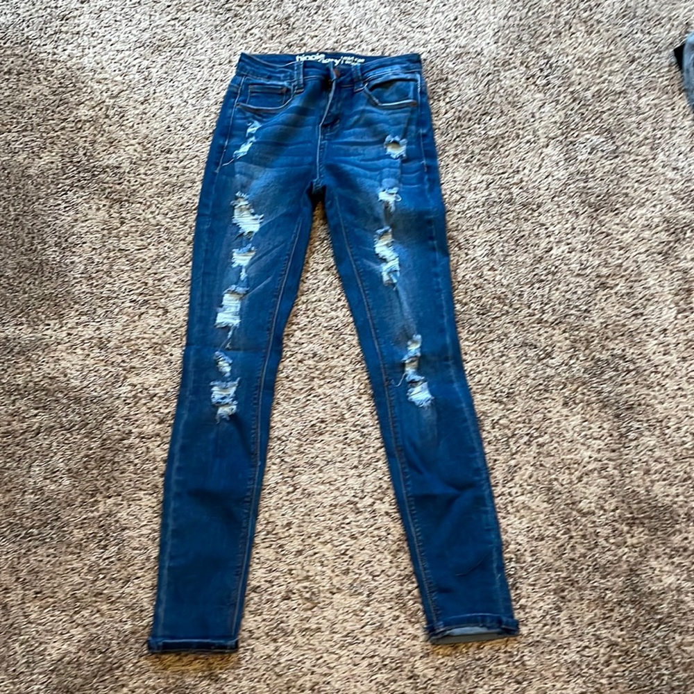 Woman’s Distressed Dark Denim Jeans